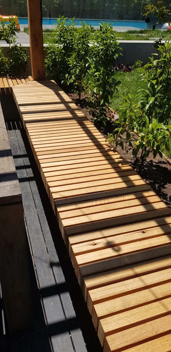 Timber slat bench beside the courtyard planting